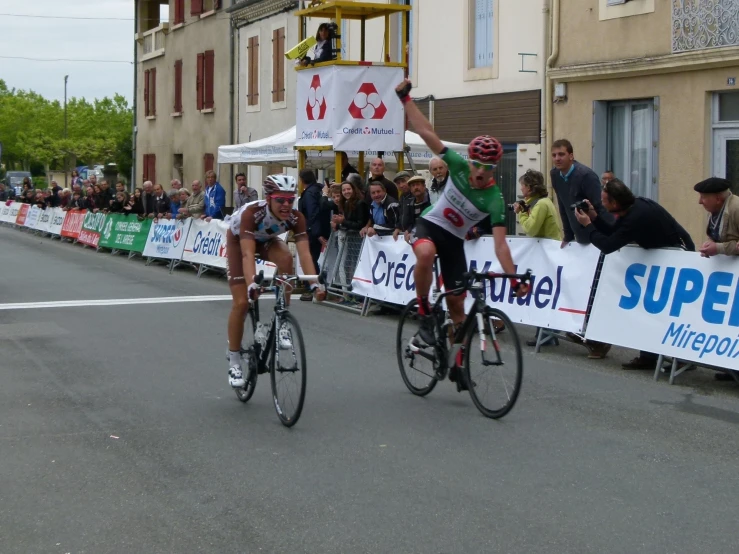 two women on bicycles racing down the street