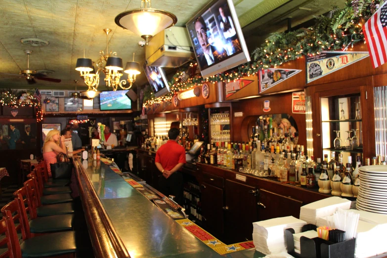 a man at a bar has his arm out for soing to eat