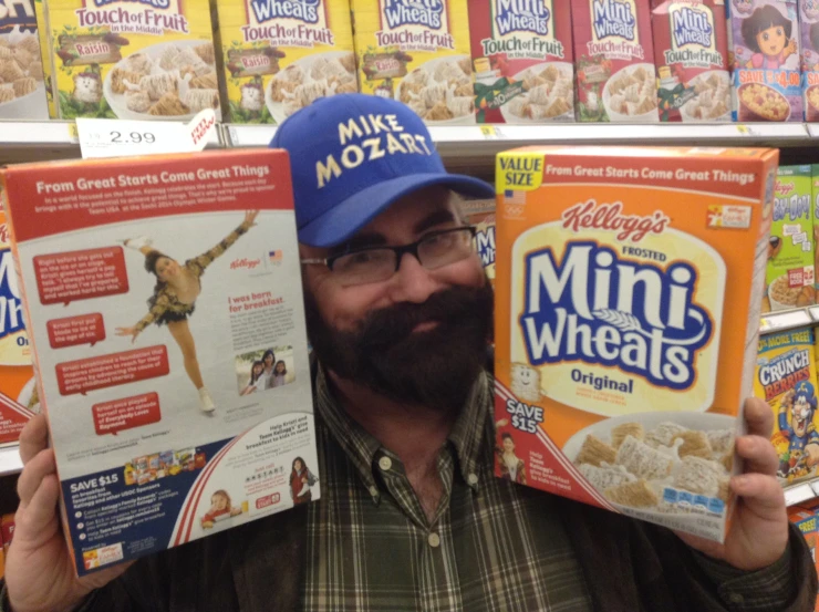 a man holding three boxes of cereal with the cereal on top