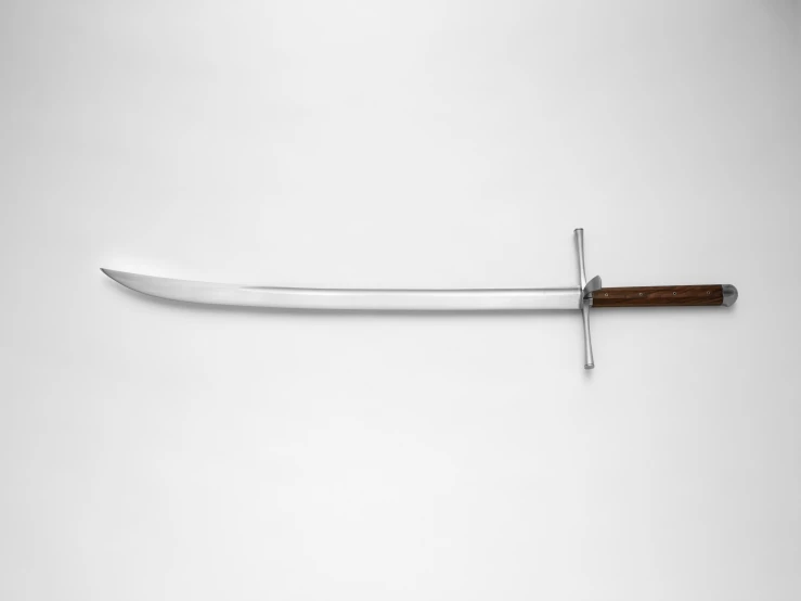 a sword is laying on a white surface