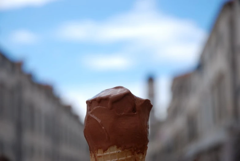a chocolate ice cream cone that is on the top