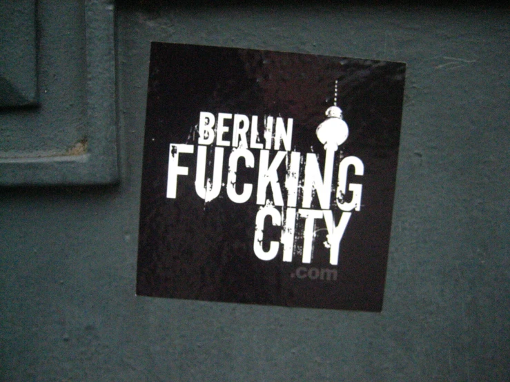 a sign that reads berlin ing city on the side of a building