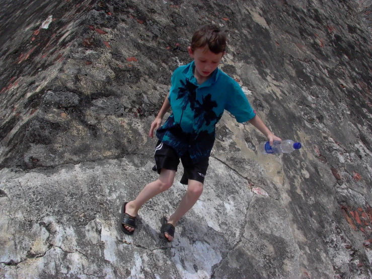 a  standing on top of an ocean rock