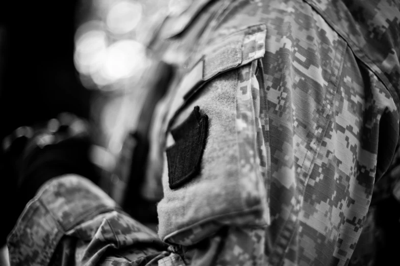 a close up of a person with a camouflage shirt on