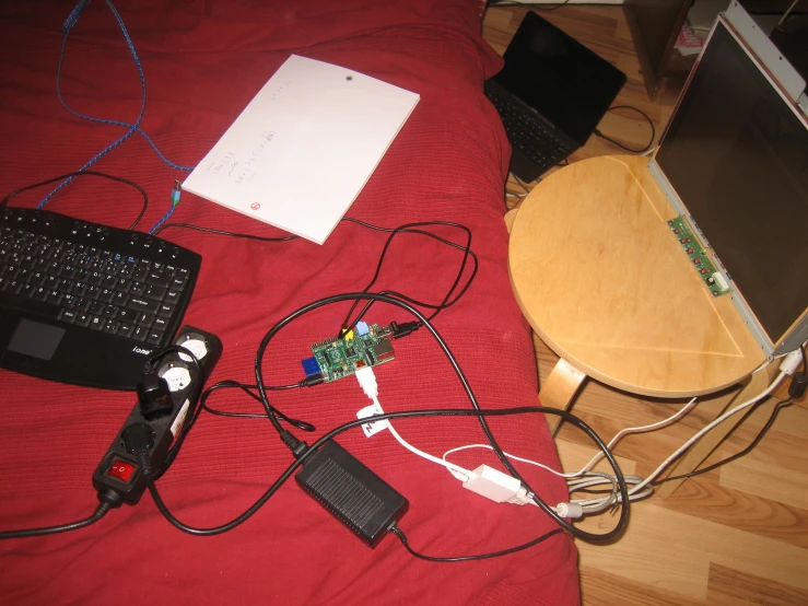 a table with two keyboards and some other devices