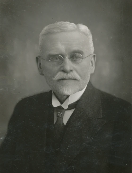 an old man with white hair wearing a suit