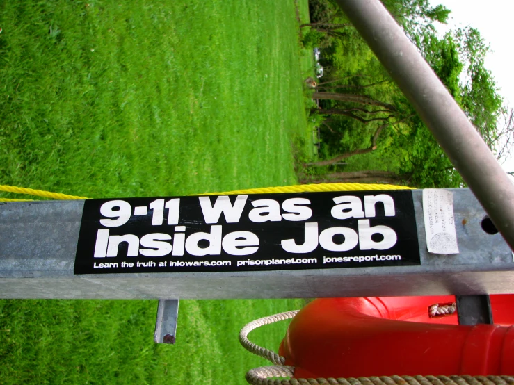 a close up of a sign attached to a pole in the park