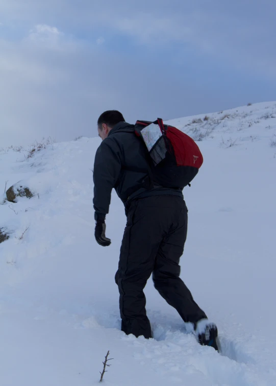 a man standing on top of a snow covered slope