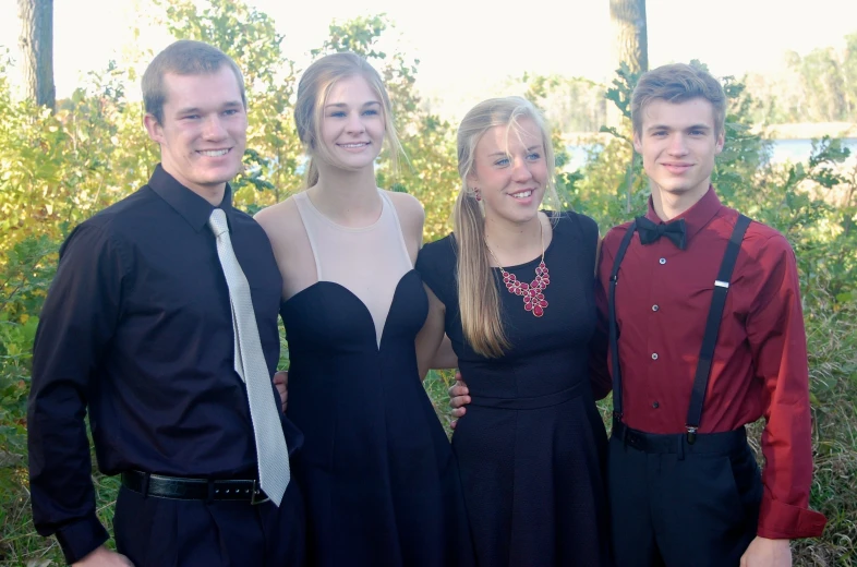 three boys and two girls pose for the camera