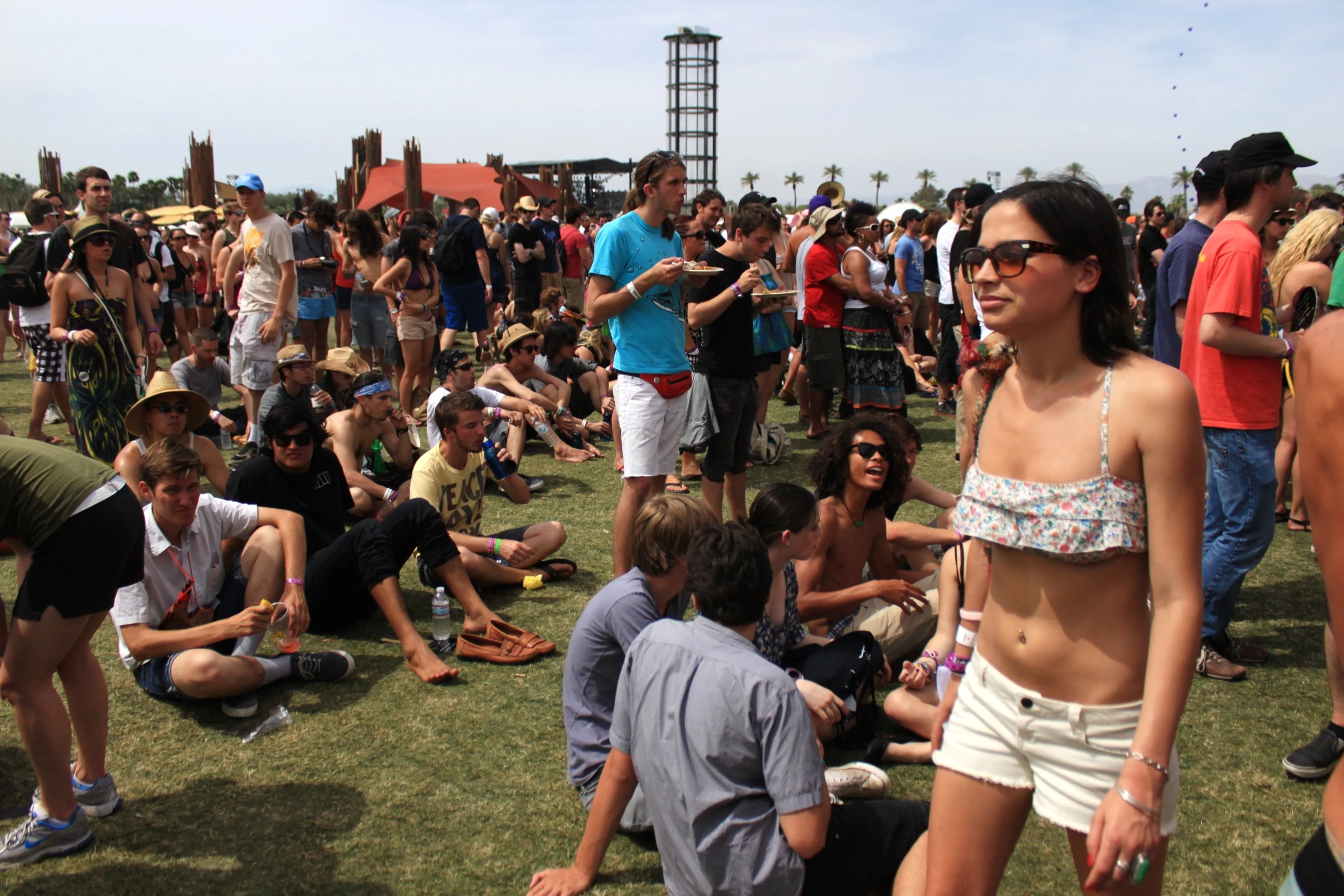 a large crowd of people are gathered outside at the park