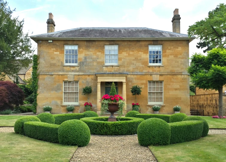 an elaborate garden design in front of a large building