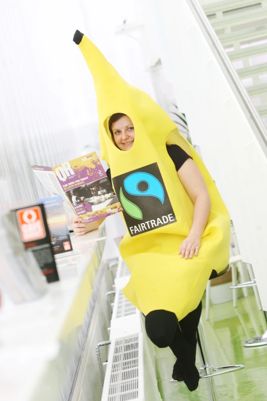 a woman in a banana suit posing with her arm wrapped around a book