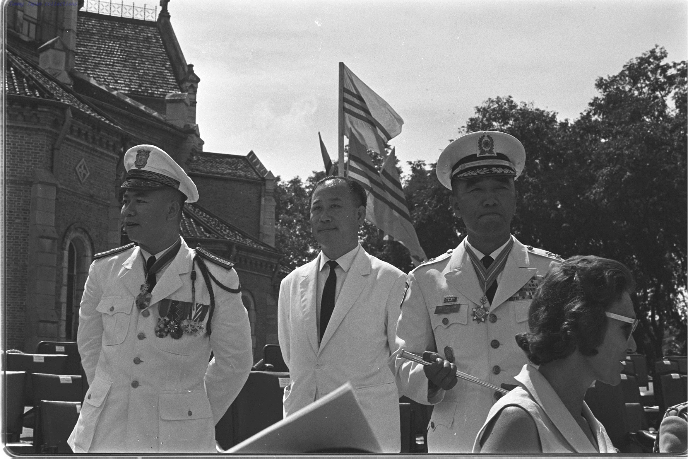 the four men in uniform are wearing matching hats and suits