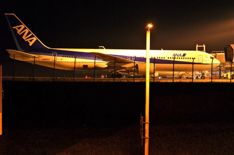 a jumbo jet taxiing on the tarmac at night