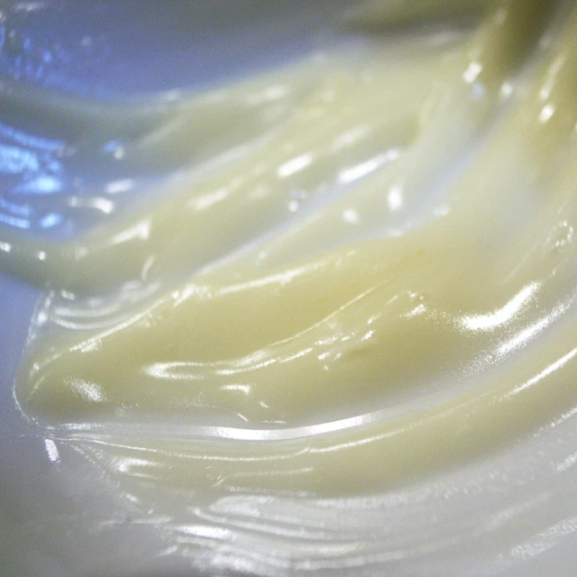 bananas sit in a bowl with yellow liquid