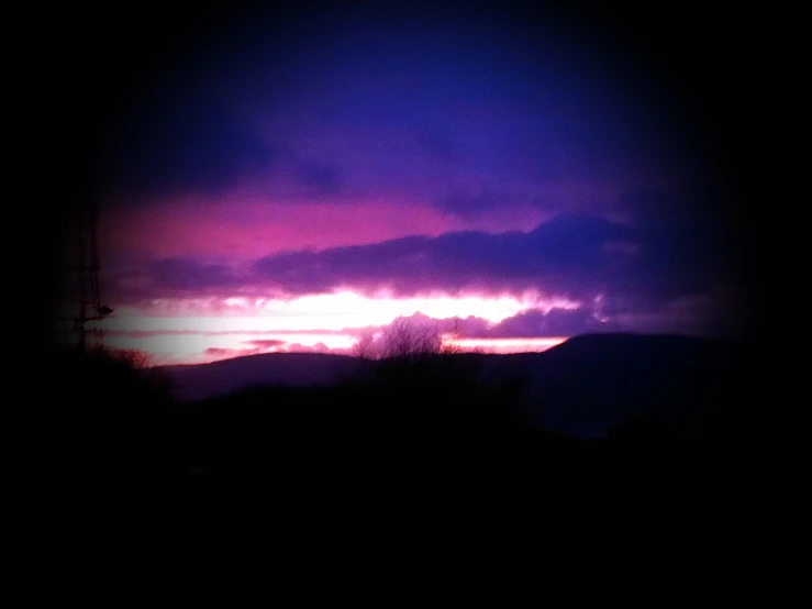 a purple sunset over the mountain range