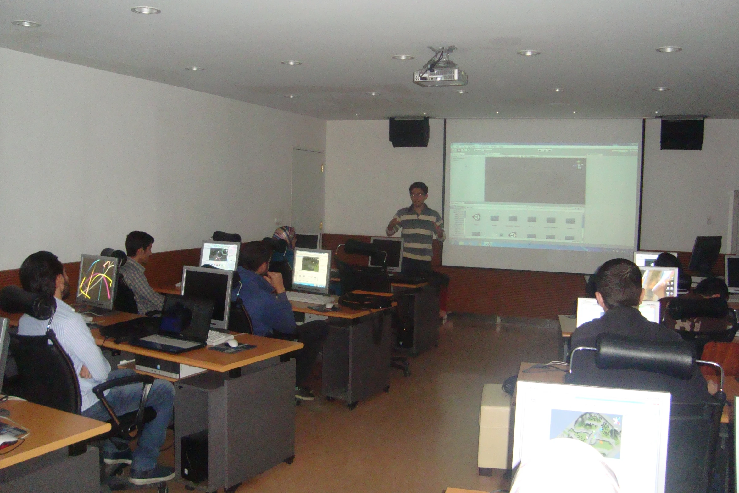 a classroom with computer desks with computers