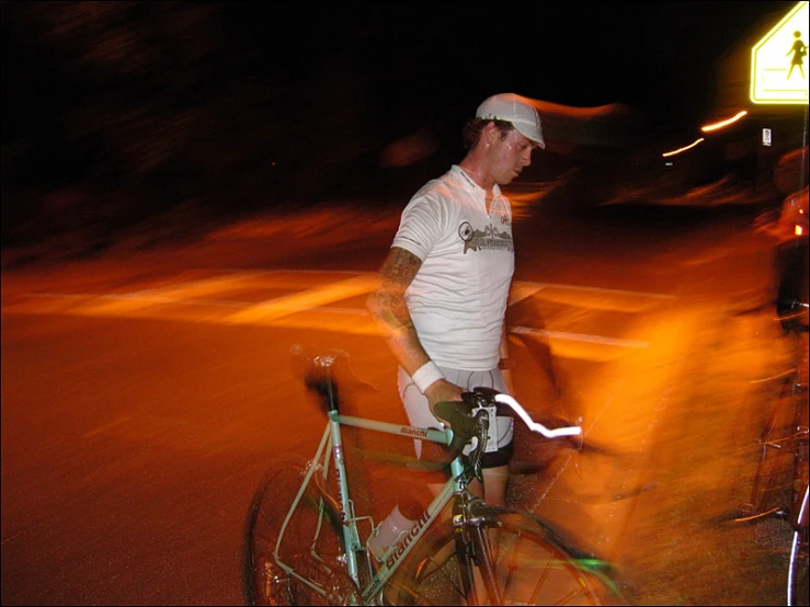 a man in white shirt riding on top of a bike