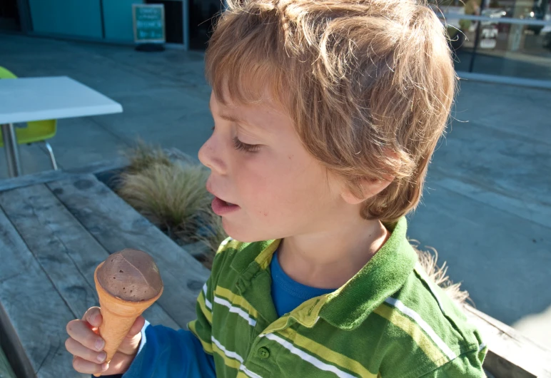 a little boy who is holding an ice cream cone