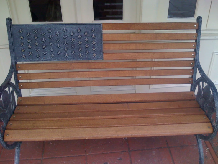 an old, empty bench on a brick patio