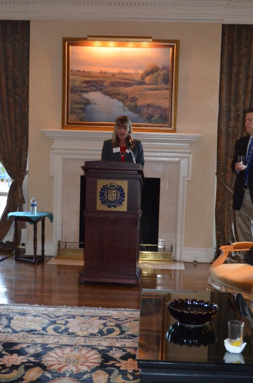 a woman at a podium talking into a microphone