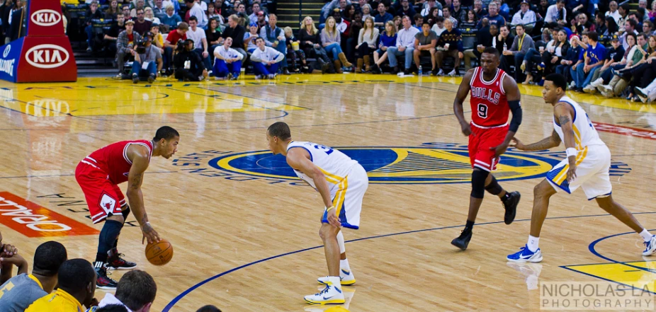 a group of men on a court playing basketball