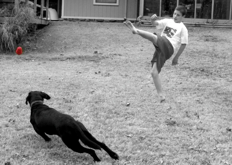 a man kicking a soccer ball on a field