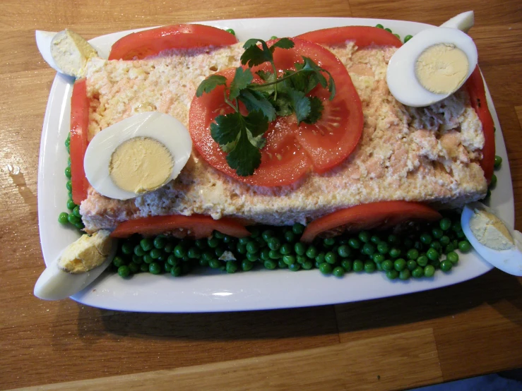 the plate is covered with eggs, tomatoes, and salmon