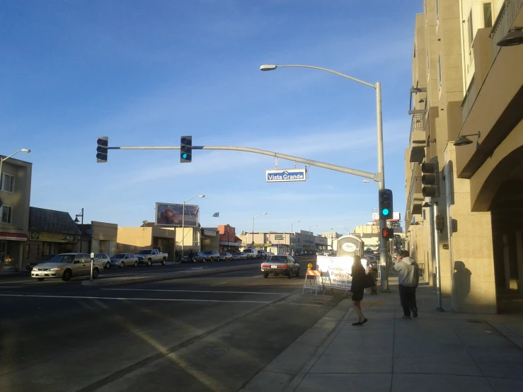 pedestrians walking on the street in a city at the intersection