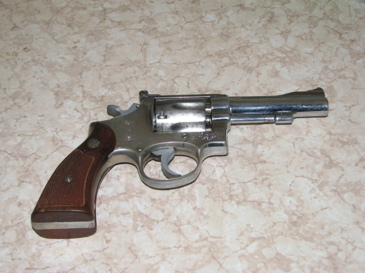 a small revolver that is laying down on the floor