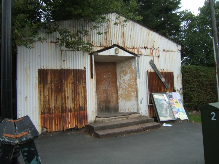 an old building with rust on it with a door