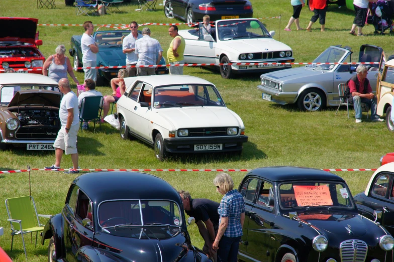 a vintage car show on a grassy field