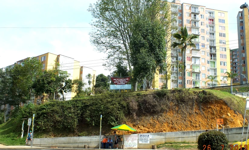 some people sitting at a table near a hill