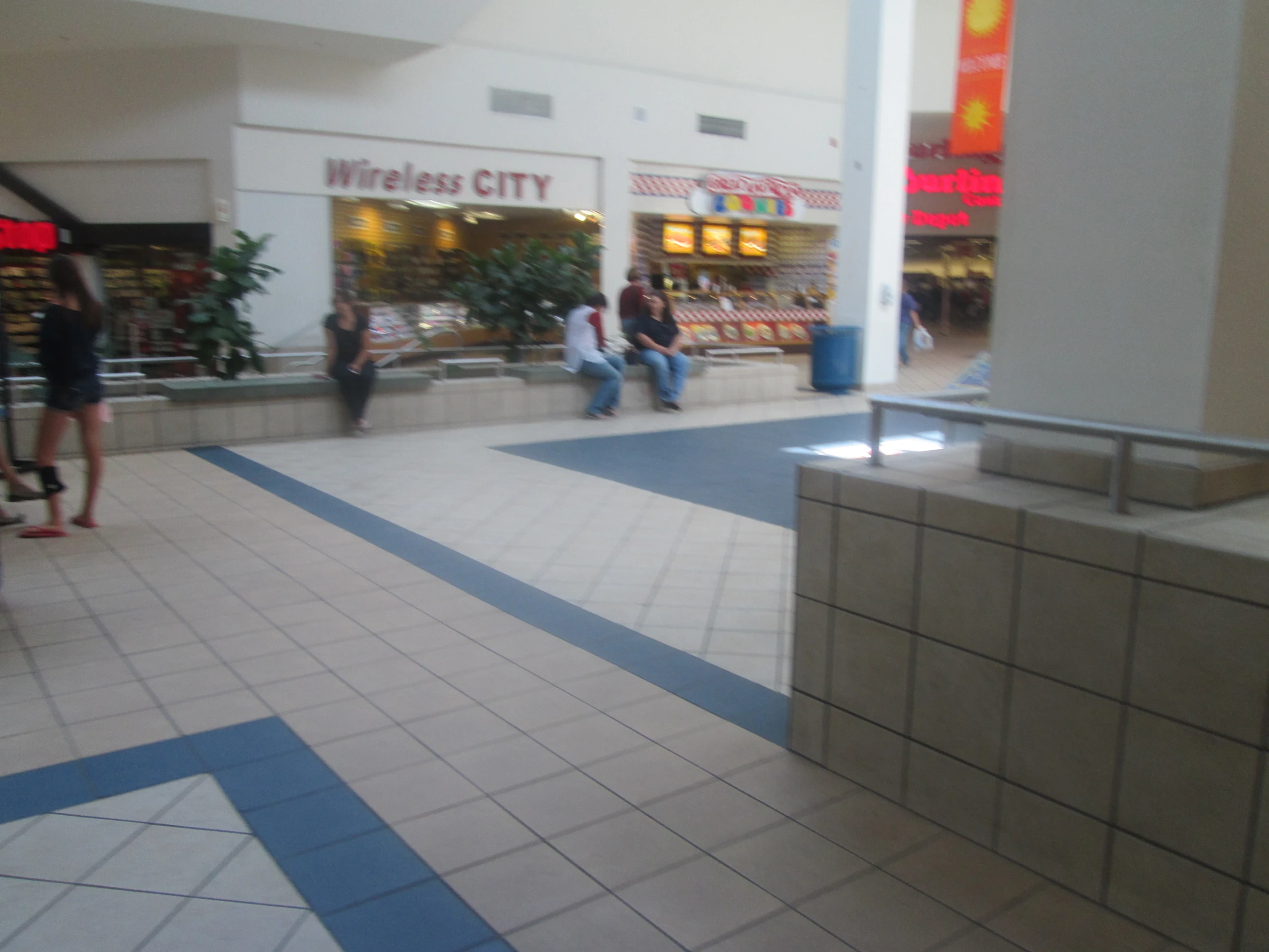 three people are walking through a building