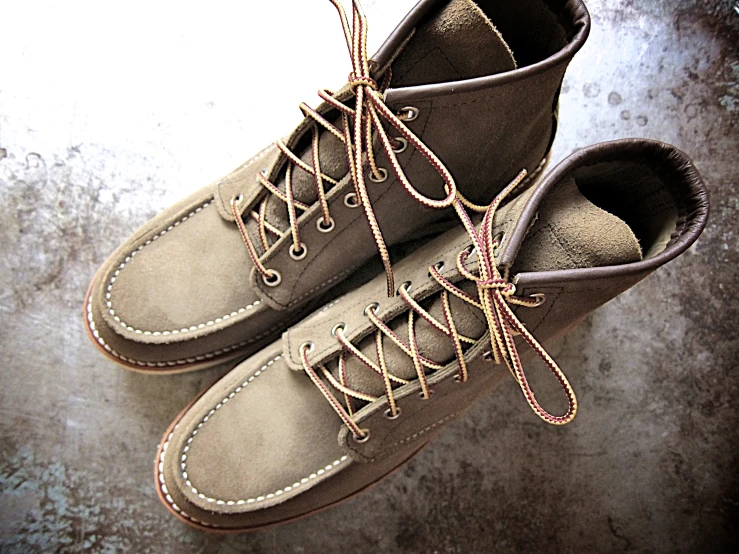 two pairs of gray shoes on a concrete floor