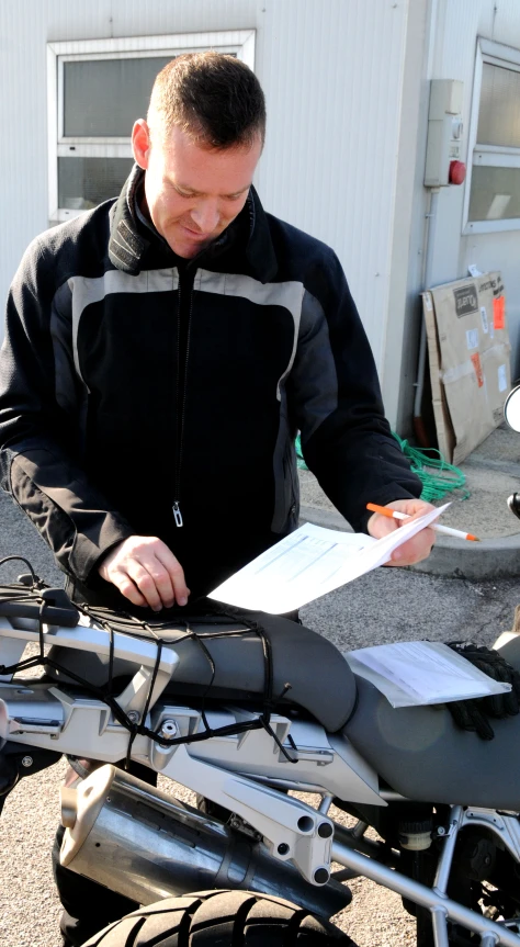 a man working on soing on his motorcycle