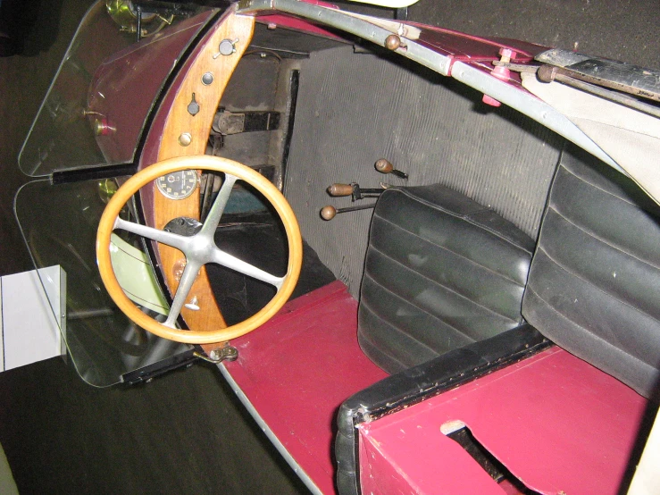 an old fashioned car has a steering wheel on the interior