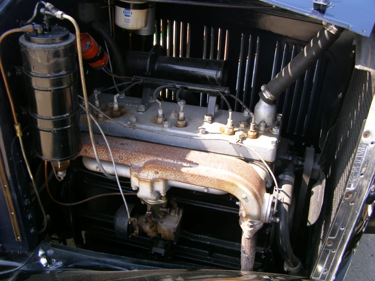 a back view of an older car, with pipes and fittings