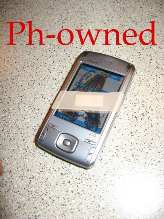 a cell phone is next to a hand with an ad in the foreground