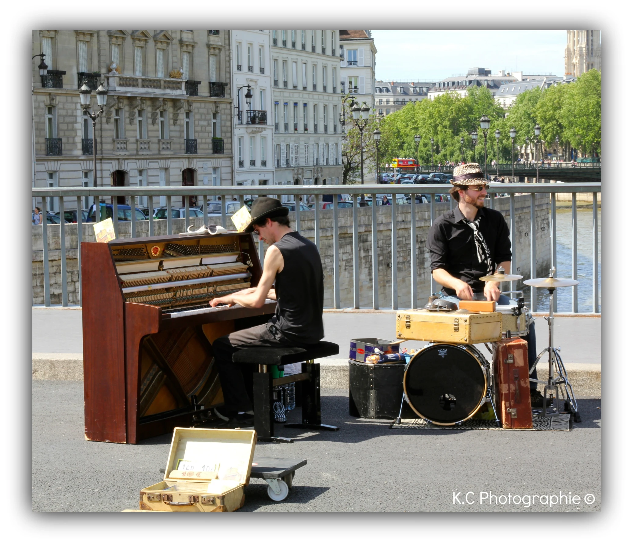 two musicians on side of the river playing music