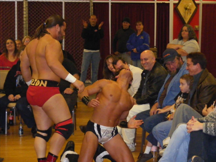 a wrestling match being attended by fans on a court