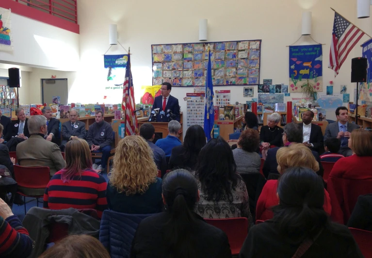 an audience is gathered in a large room