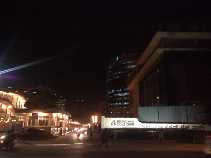 people crossing the street at night in a city