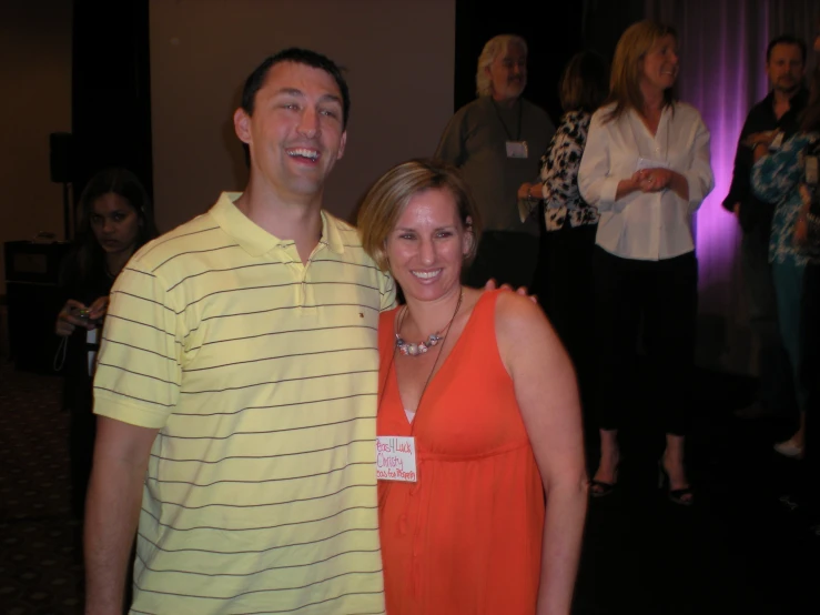 a smiling man and woman pose for a po