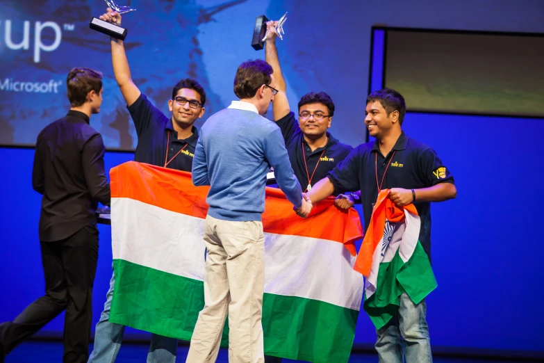 several people holding up their trophies for an event