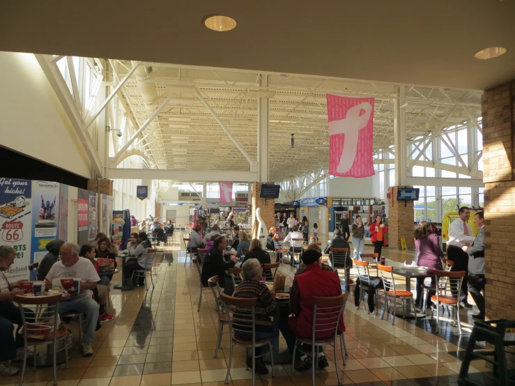 people are in the middle of a large hall eating food