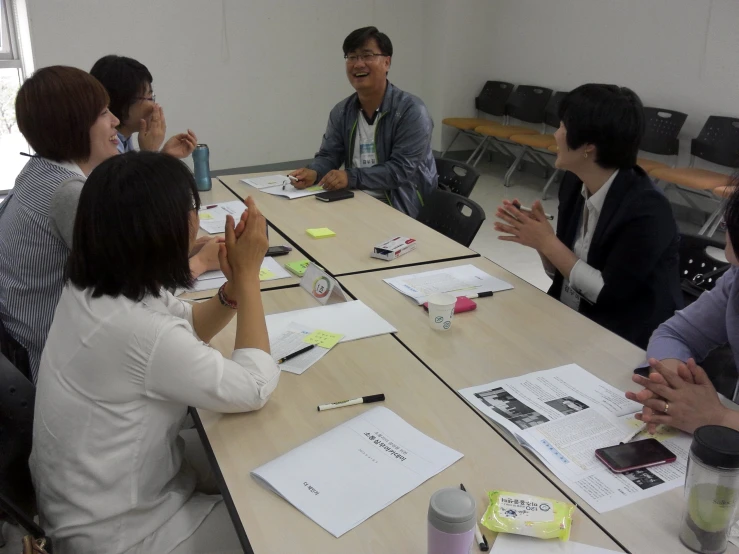 group of people sitting around a table in an office setting