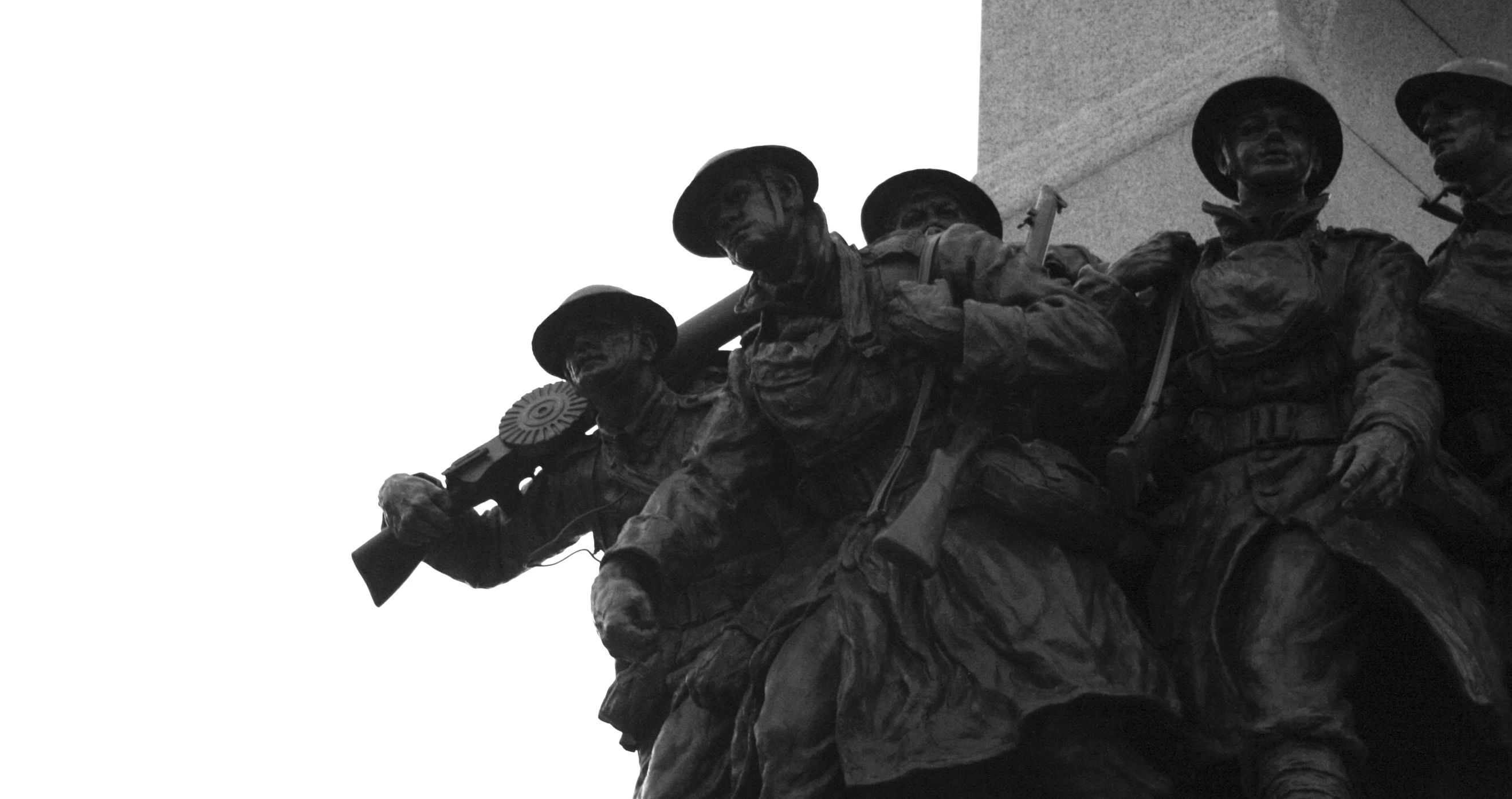 a group of soldiers holding rifles standing in front of a statue