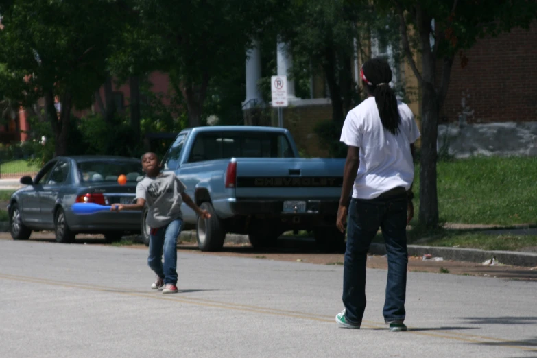 the boys are skateboarding down the street