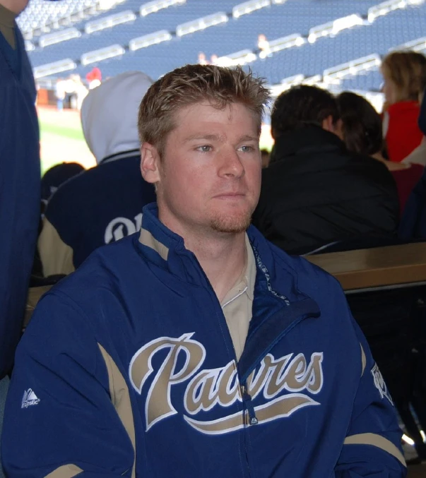 a man with a blue jacket at a game